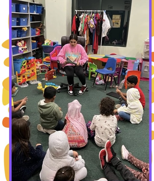 Myra reading to children in classroom