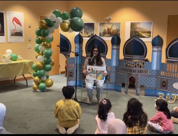 Myra reading to kids at event