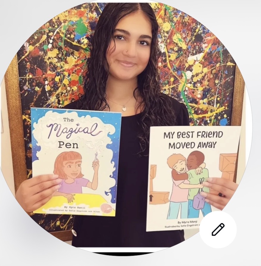 Myra Manji holding her book The Magical Pen